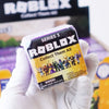 A hand holds a Roblox Series 3 Collect Them All figure packaged in its plastic case.