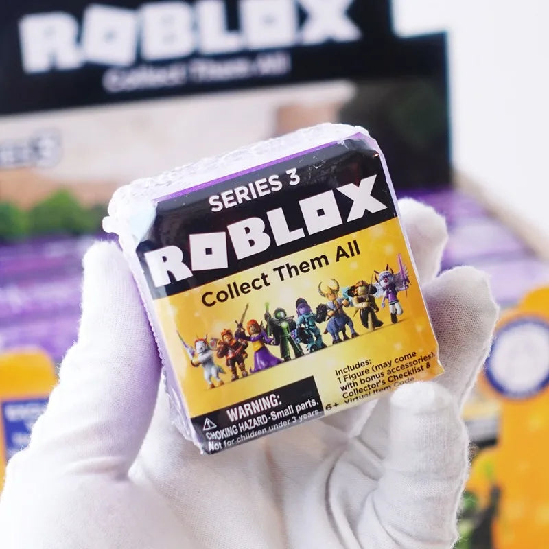 A hand holds a Roblox Series 3 Collect Them All figure packaged in its plastic case.