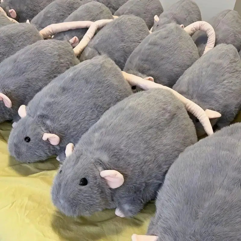 A close-up view of several gray plush rat stuffed animals piled together.