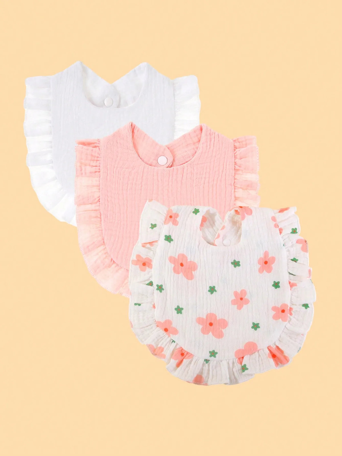 A set of three pure cotton muslin baby bibs in white and pink with floral embroidery