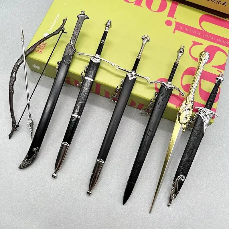 A collection of nine metal sword replicas, including a longsword and a rapier, displayed on a yellow box.