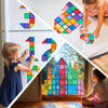 A child is building a colorful structure using magnetic tiles and a vehicle set on a table.