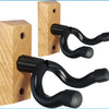 A solid wood guitar wall mount hanger with black, curved hooks for hanging instruments.