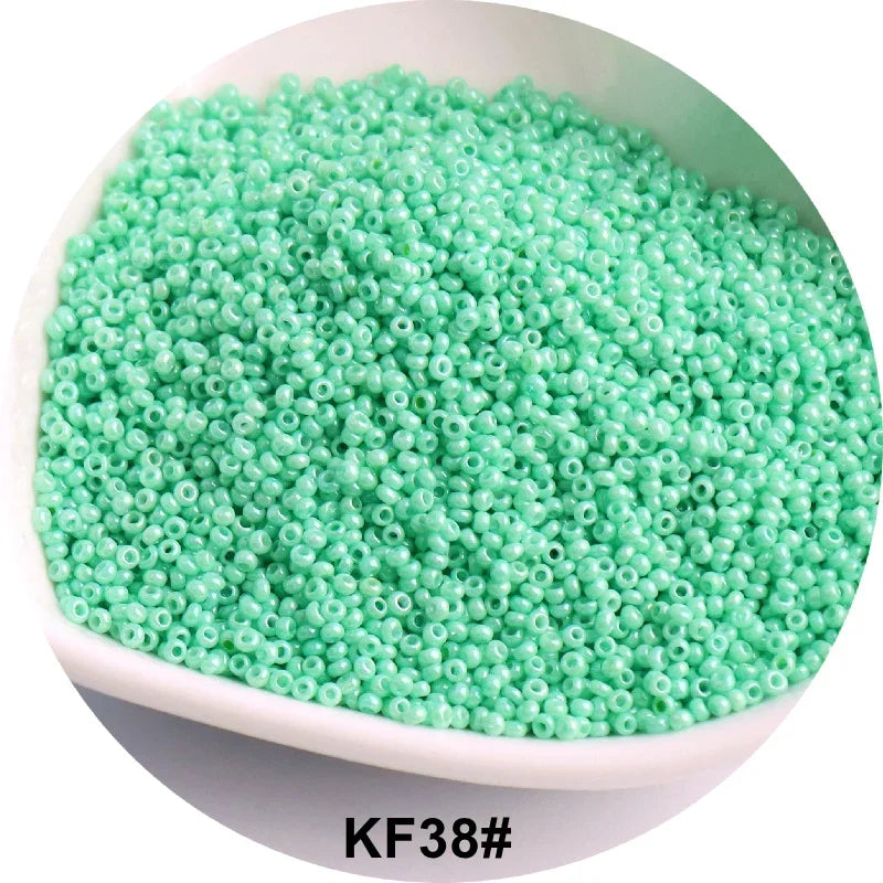 A pile of light green seed beads is shown in a white bowl.