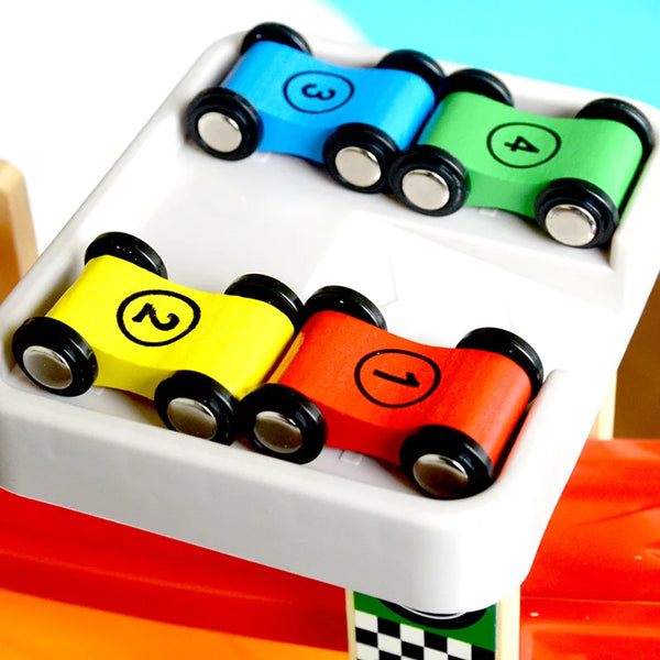 A wooden sliding race car toy set with numbered cars in blue, green, and red colors inside a white container.