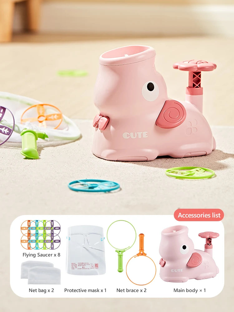 Pink foot launcher toy set with a main body, protective mask, and catching nets on a light surface.