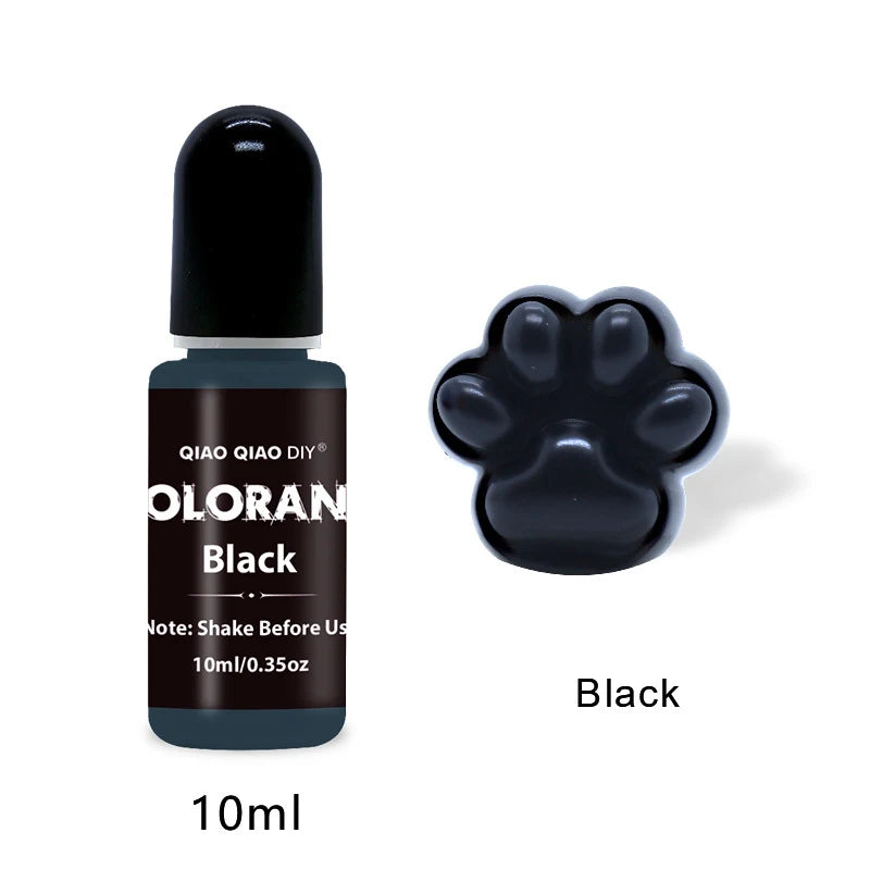 A dark glass bottle of black liquid color dye labeled QIAO QIAO DIY Black with a paw print shape on the cap.