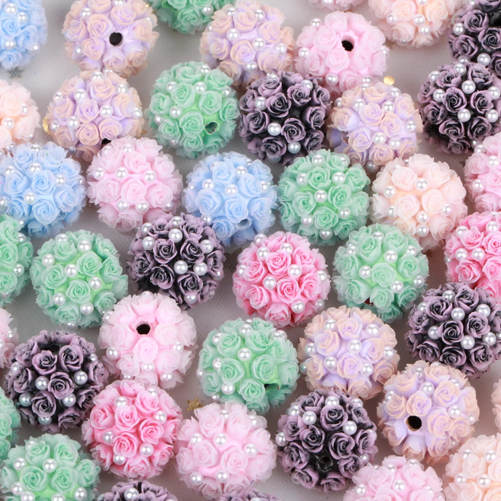A variety of pink, purple, and green rose flower ball acrylic beads for jewelry making