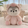 A pink husky plush toy with soft fur and ears sitting on a white surface.