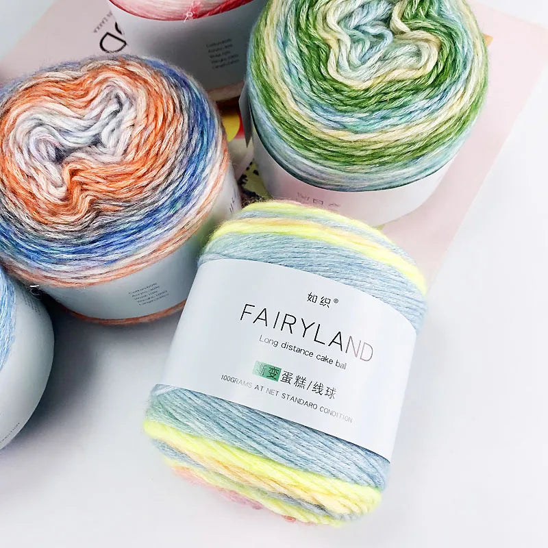A ball of multi-colored gradient yarn, featuring shades of green, blue, yellow, and white.