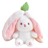 A white plush toy shaped like a bunny with pink ears and a green sprout.