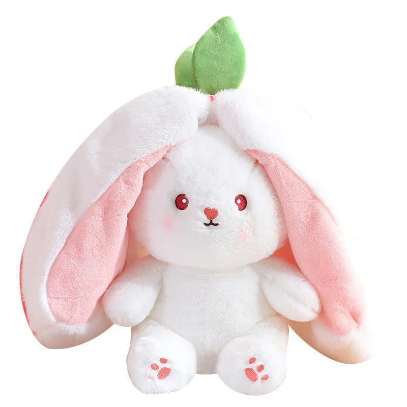 A white plush toy shaped like a bunny with pink ears and a green sprout.