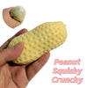 A hand holds a yellow squishy stress ball next to a small, round version.