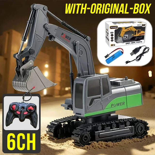 A gray and green 1:24 scale remote control excavator with an original box and a controller shown on sand.