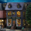 A detailed miniature wooden dollhouse kit of a pink princess villa with illuminated LED lights.