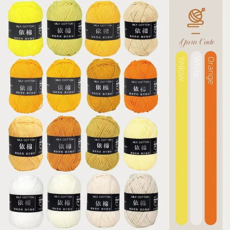 A collection of various colored milk cotton yarn skeins in yellow, orange, and white for knitting and crochet.