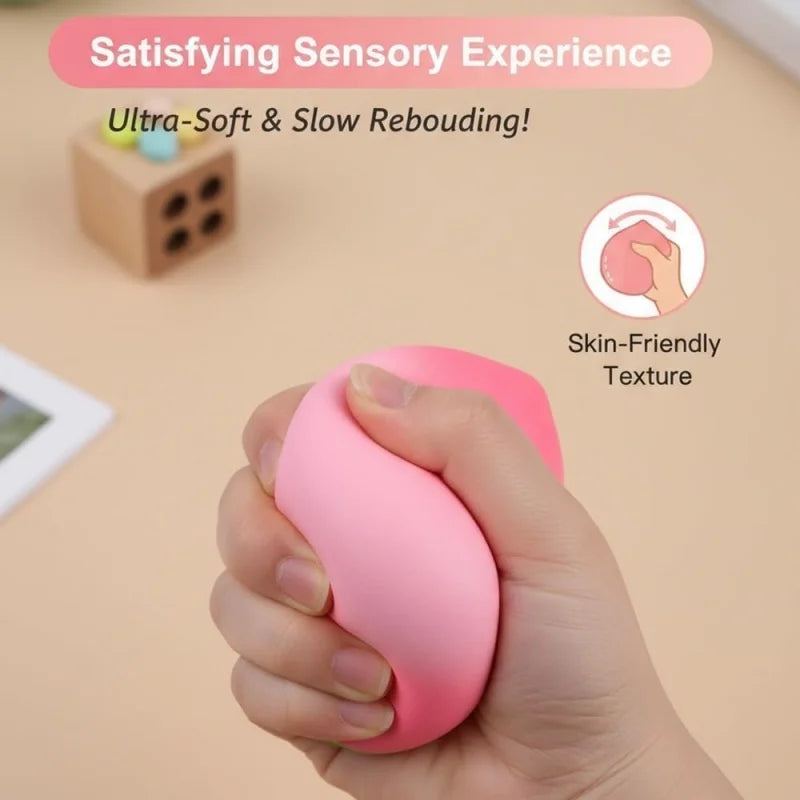 A hand is squeezing a pink, squishy stress relief fidget toy with a smooth texture.