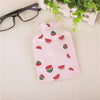 Pink portable hot water bottle with a cozy cover featuring illustrations of sliced watermelon pieces.
