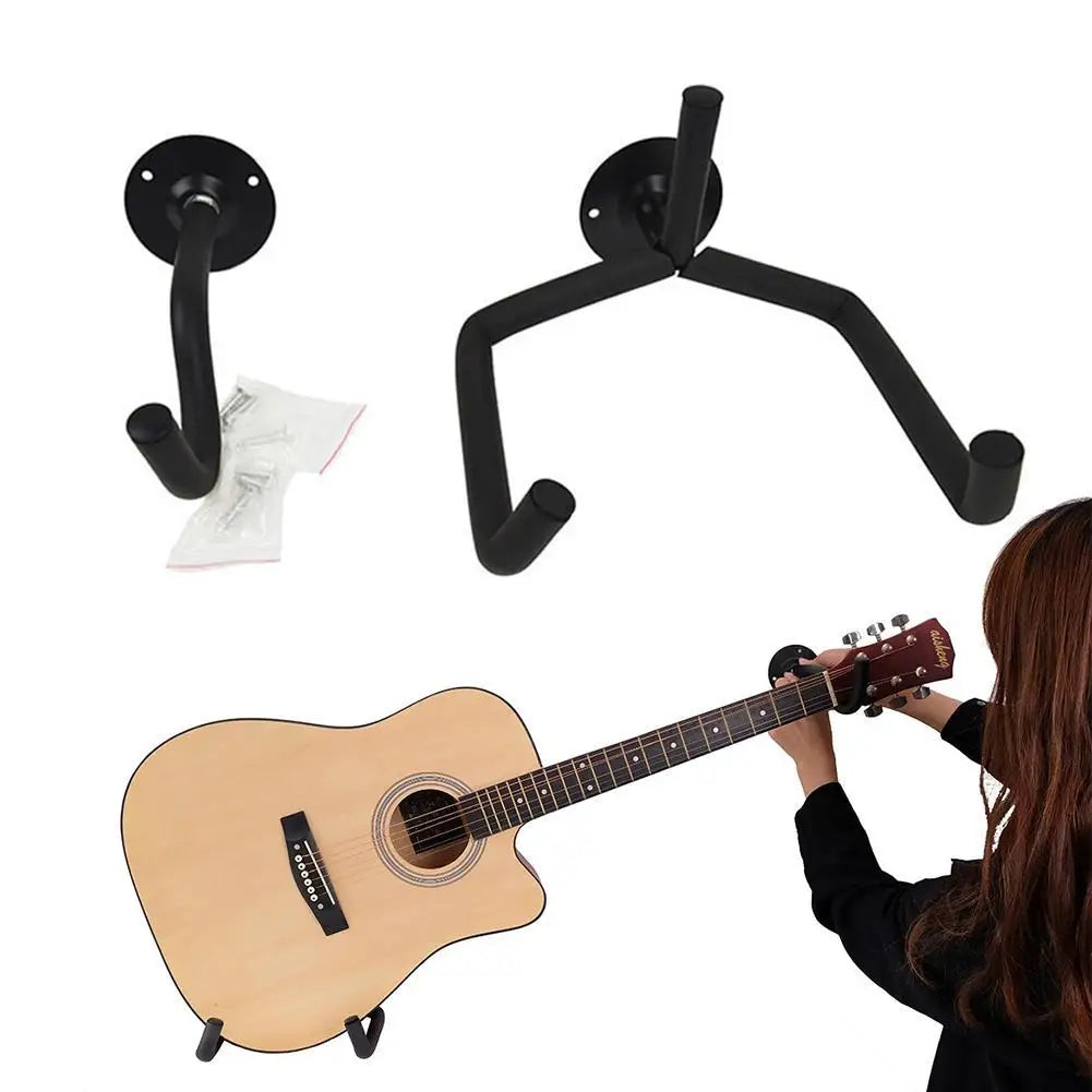 A black metal guitar wall mount hanger is shown next to an acoustic guitar.