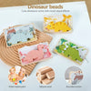 A set of dinosaur beads and wooden toys including dinosaur beads, natural wood blocks, and rounded corners.