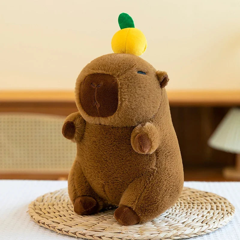 A brown capybara plush toy with a yellow head, sitting on a woven mat.