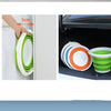 A hand measures 5cm on a white appliance, demonstrating the size of a space-saving collapsible bucket with a lid.