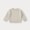 A cream-colored knit sweater with a diamond pattern shown flat lay.