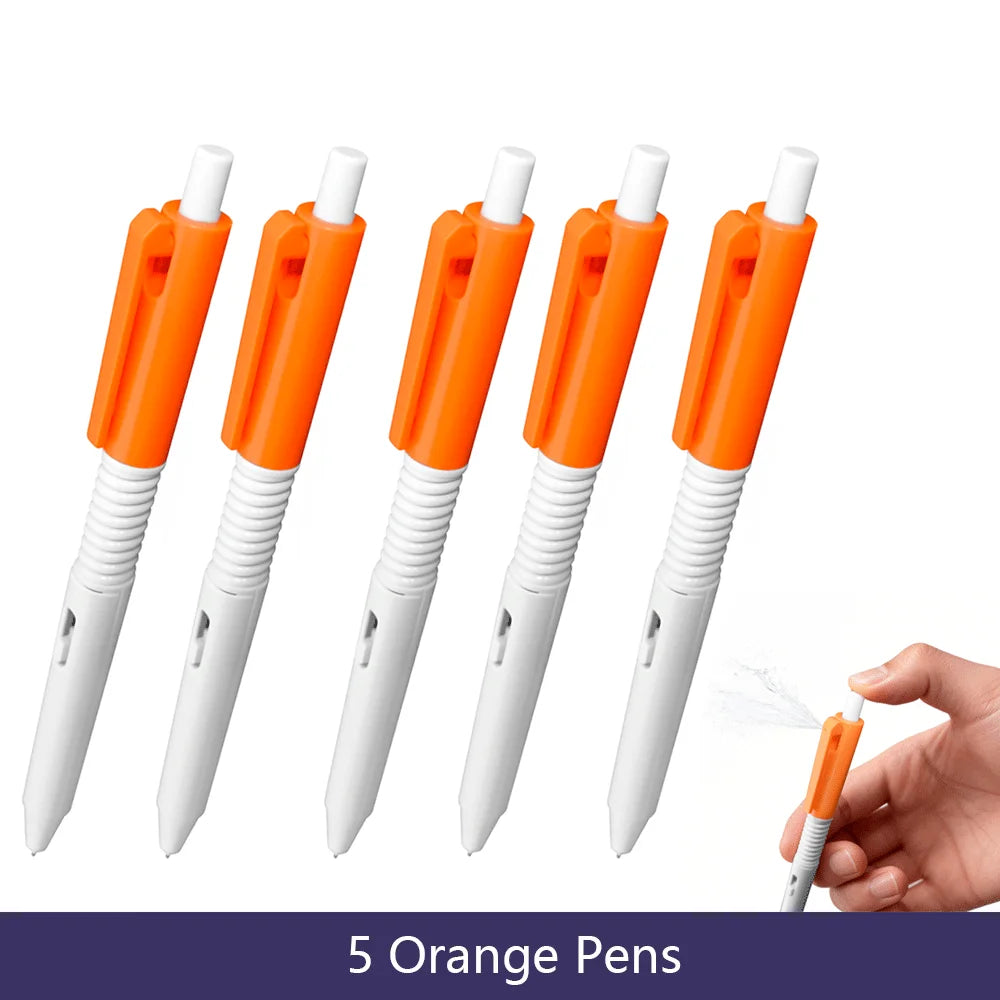 Five orange squirt water spray ballpoint pens shown against a white background.