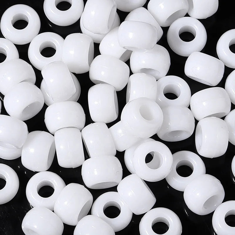 A close-up view of a pack of white rainbow pony beads for jewelry making and craft projects.