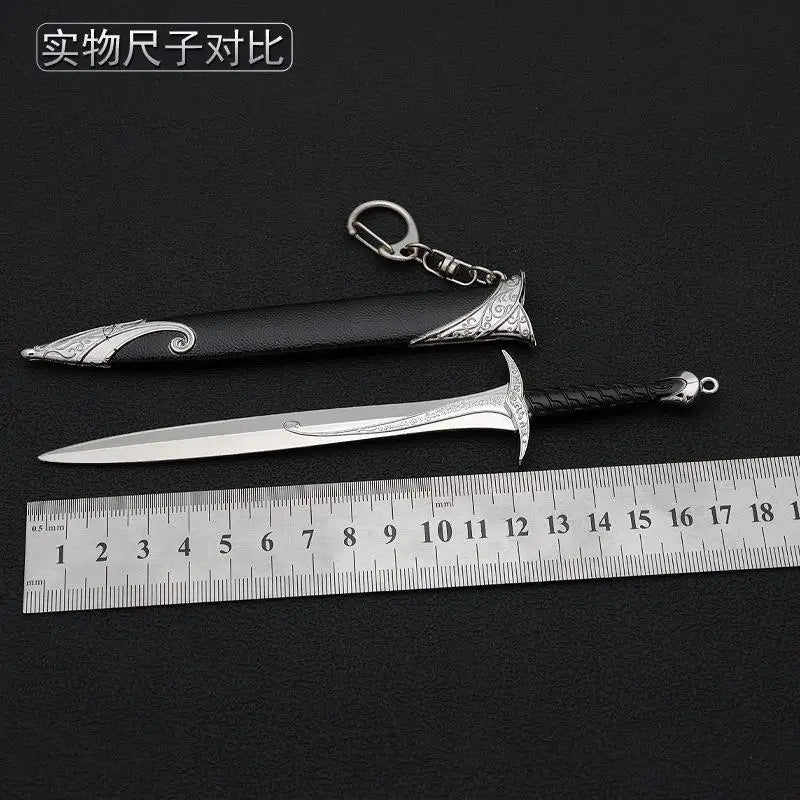 A collection of replica swords, including a metal blade and a black handle with silver inlay, displayed next to a ruler.