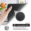 A close-up of a black anti-slip rubber base on a gaming mouse pad with stitched edges.