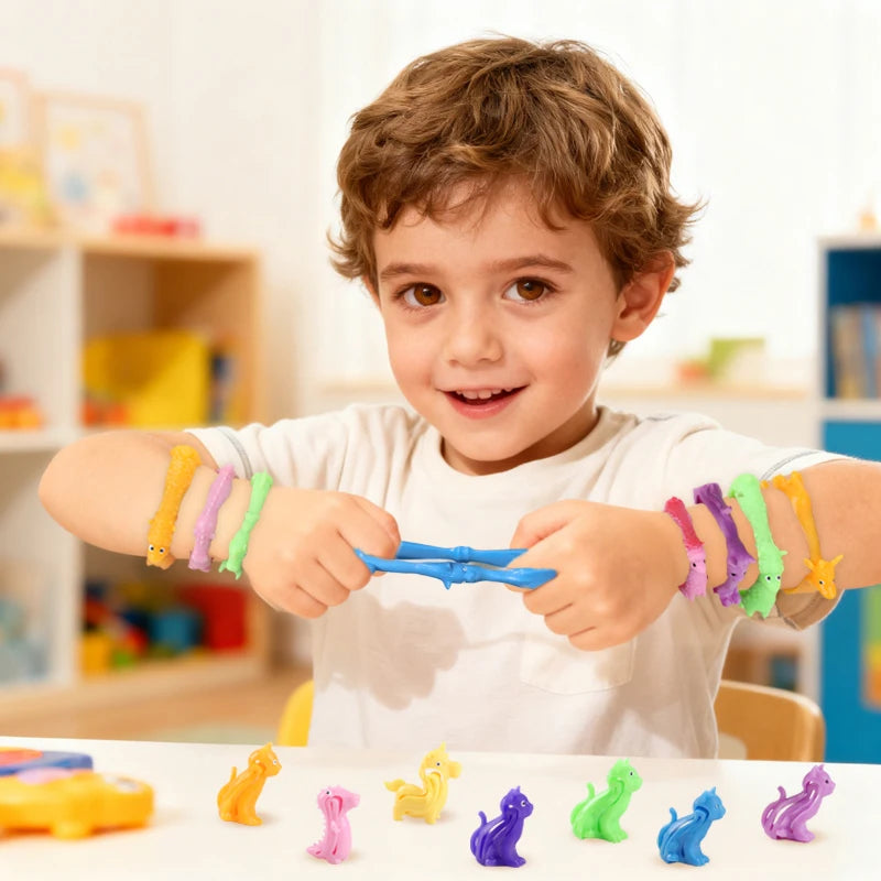A young boy is wearing and manipulating colorful animal and dinosaur sensory stress bracelets.