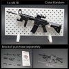 A black 1:6 scale military submachine gun model kit displayed on a white pegboard with separate bracket parts.