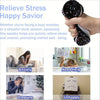 A hand squeezes a black and pink squishy stress relief toy used to relieve anxiety, pressure, and unhappiness.