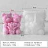 A pink silicone mold shaped like a bear and a rose, used for making candles or DIY crafts.