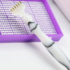 A white diamond painting pen set with interchangeable tips resting in a purple tray.