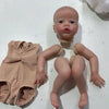 A realistic reborn baby doll kit with painted details and a cloth body is displayed on a white surface.