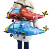 Two foil balloon model planes in red and blue are held by a person for birthday party decoration.