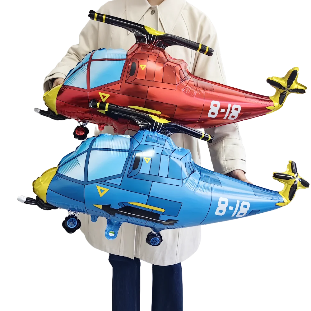 Two foil balloon model planes in red and blue are held by a person for birthday party decoration.