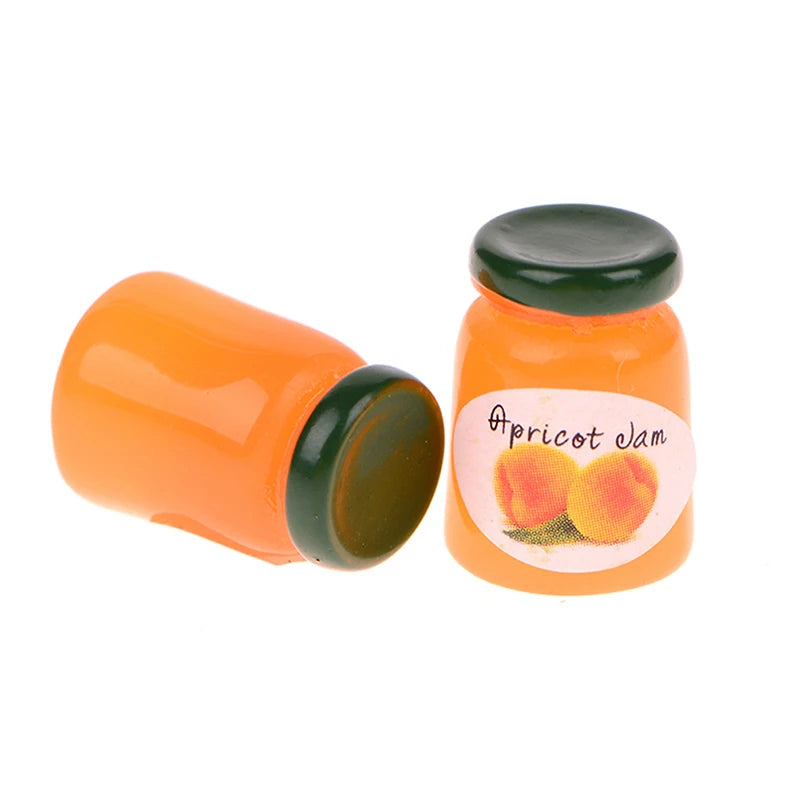 A small orange ceramic jam jar with a green lid and a label showing apricot jam fruit.