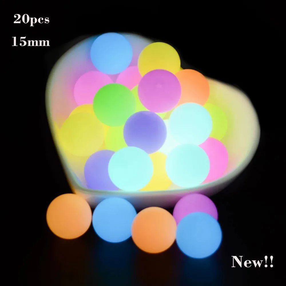 A collection of glow-in-the-dark silicone beads in various colors are displayed in a white dish.