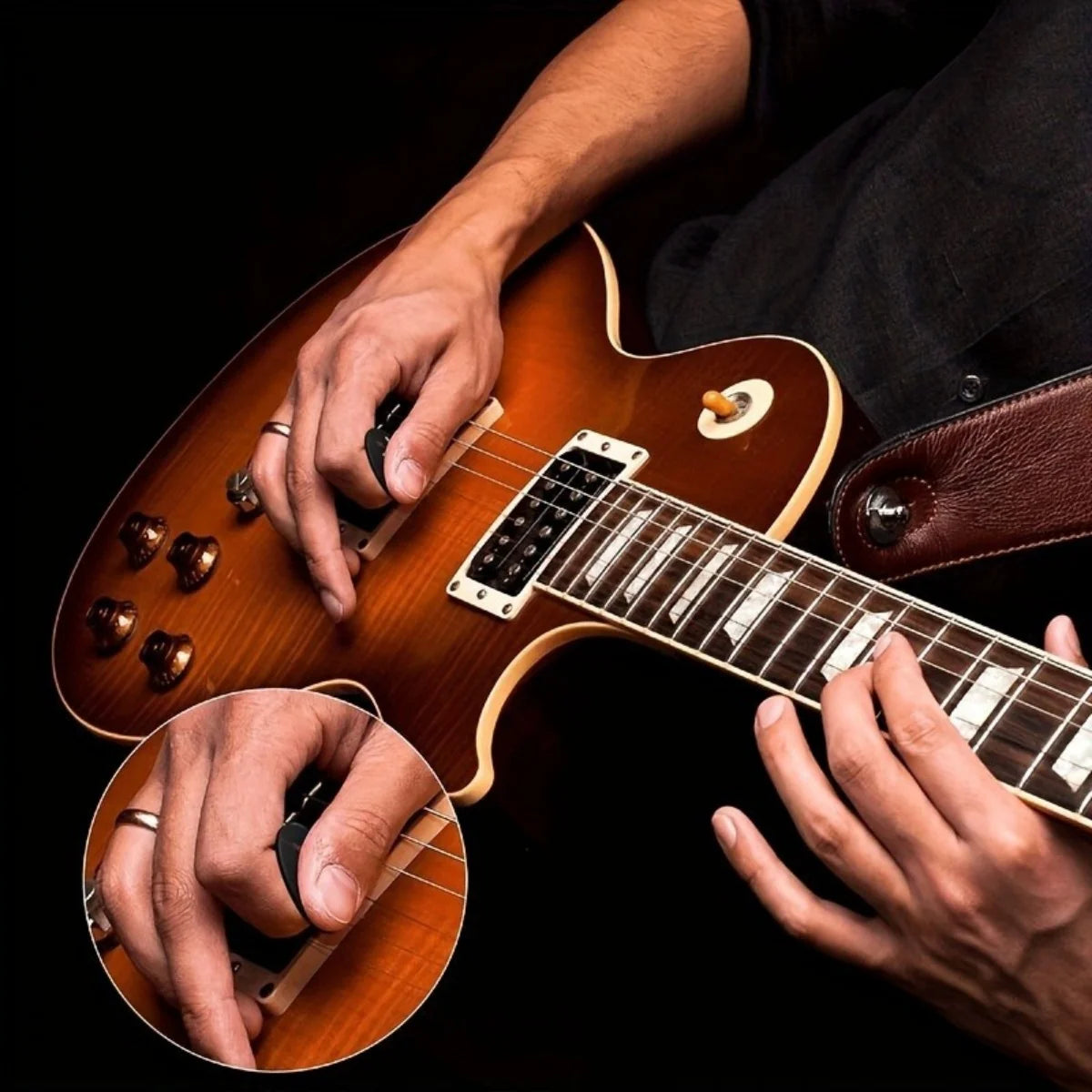 Hands playing an acoustic guitar with decorative picks and a leather keychain holster.