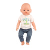 A baby doll wearing a white t-shirt with a tree design and blue jeans.
