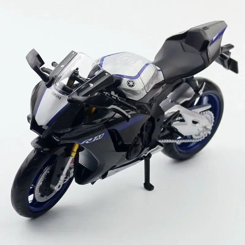 A black and silver Yamaha YZF-R1M diecast motorcycle model shown in a profile view.