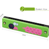 A green wooden harmonica with a cartoon animal design showing musical notes on the body.