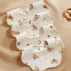 A stack of white soft waxy cloth bibs for babies, showing features like strong water absorption and breathable fabric.