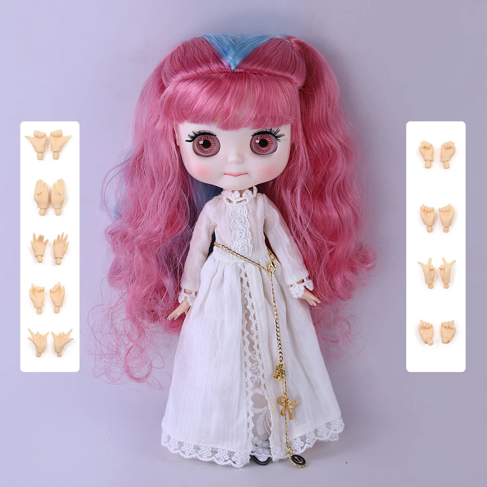 A pink-haired fashion doll with a pouty face wearing a white dress and gold jewelry.