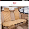 A beige car seat protector with a quilted pattern is shown installed in the back seat of a vehicle.