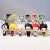 A collection of Hunter x Hunter anime character resin keychains with various hair colors and outfits displayed on a white sur