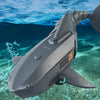 A gray remote control swimming shark toy is shown underwater with bubbles, featuring 2.4 GHz remote control and gear accelera